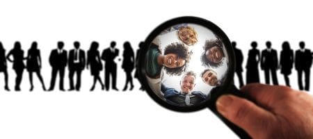 looking at people through magnifying glass